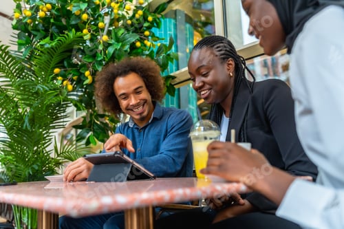 Preview: Friends meeting in cafe using digital tablet and smiling