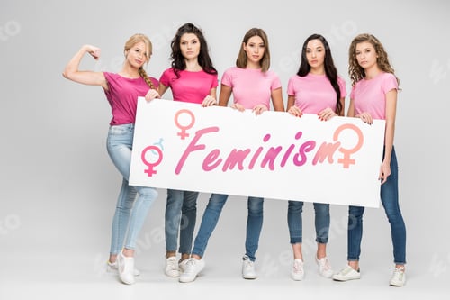 Preview: serious girls holding large sign with feminism lettering on grey background
