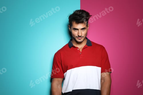 Preview: Young man with trendy hairstyle posing on color background