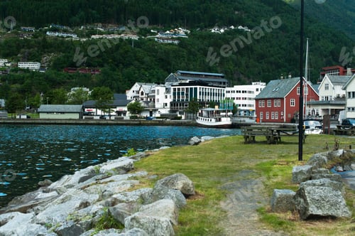 Preview: scenic view of buildings on riverside with mountains on background in Norway