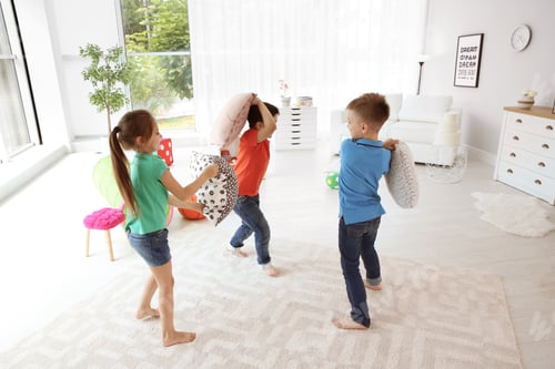 Preview: Children Playfully Engage in a Pillow Fight Indoors