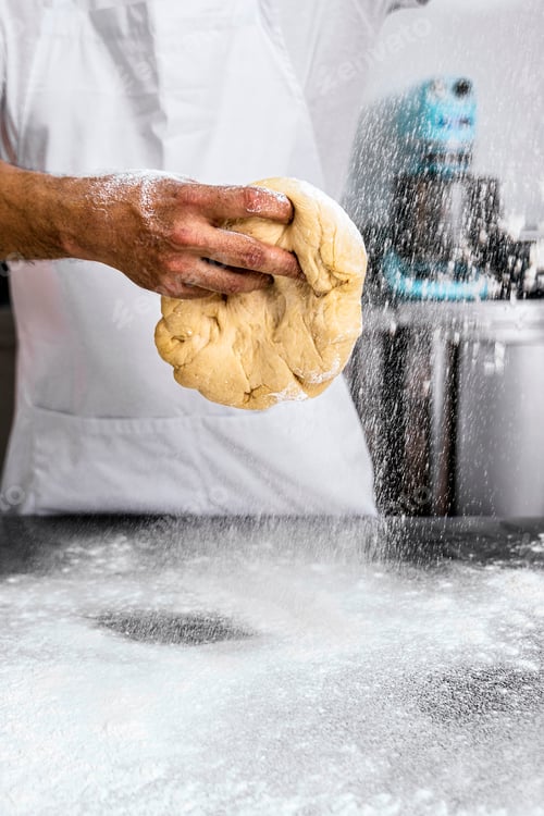 Preview: Master Baker. Baker man pours flour into the dough.