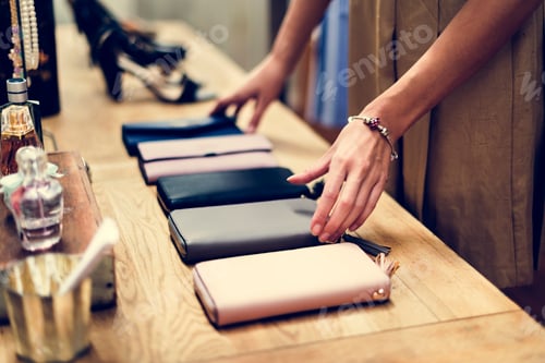 Preview: woman adjusting purses for sale