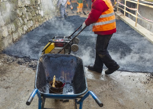 Preview: Lot of construction workers working and making a mini-roller asphalt road