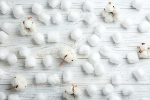 Preview: Flat lay composition with cotton balls and flowers on white wooden background
