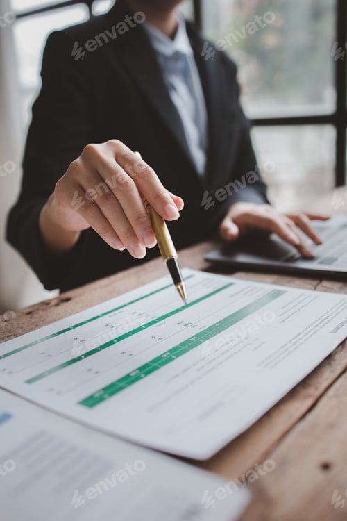 Preview: Businessman in a private office at his company and is reviewing company financial documents, senior