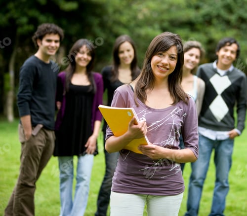 Preview: Happy Student Outdoors With A Group Of Friends Behind Her