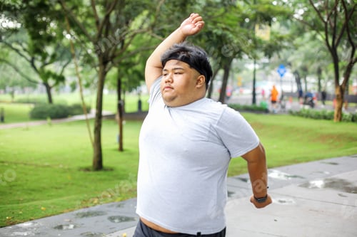 Preview: Overweight Guy In Sportswear Warming His Body While Walking