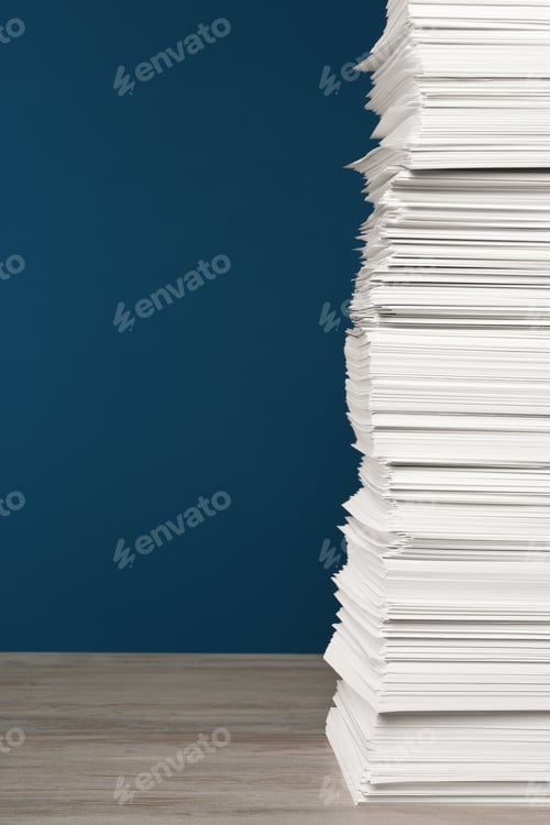 Preview: Stack of white paper sheets on wooden table against blue background, space copy text