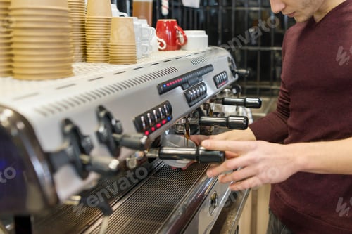 Preview: Closeup of coffee making process, hands of barista using a coffee machine