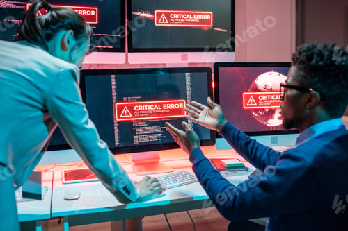 Preview: Young African male programmer complaining female colleague about problem in work of computers
