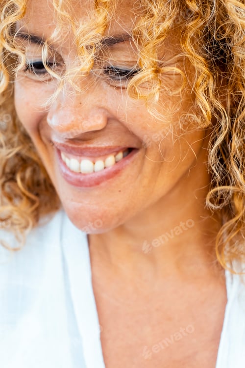 Preview: Happy cheerful curly long hair attractive adult woman portrait in outdoor. Middle age happiness