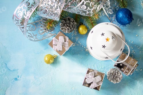 Preview: Christmas fir branch, lantern and gifts on a blue stone background.