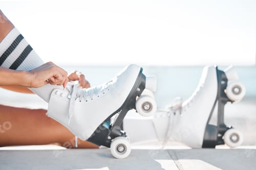 Preview: Closeup of roller skate boots on the floor outdoor on the promenade at the beach during spring. Per