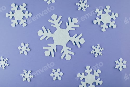 Preview: White snowflakes on backround. Color of the year 2022, veri peri. Christmas New Year holiday concept