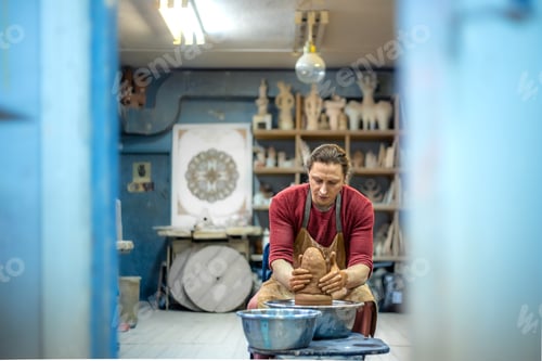 Preview: A man is making pottery on a potter's wheel. A man makes pottery. Clay modeling.
