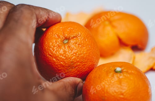 Preview: African American man holding orange