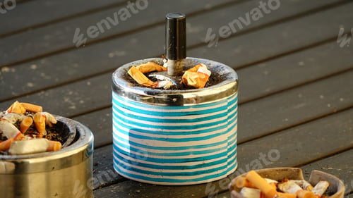 Preview: Wooden table with ashtrays filled with cigarette butts
