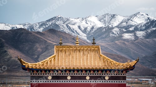 Preview: Majestic view of vast snow-capped mountains looming over the Tibetan Buddhist temples.