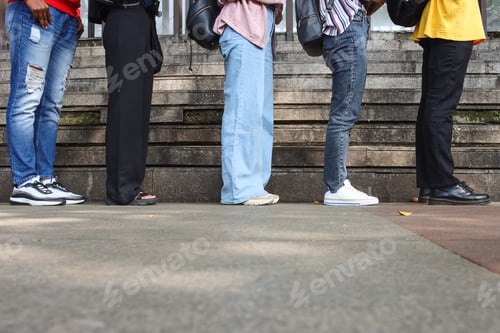 Preview: Cropped image of people leg standing and waiting patiently in line