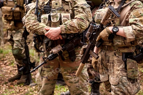 Preview: Close up hands american soldiers men dressed military uniform holding weapon in forest at nature