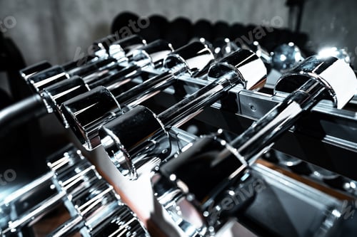 Preview: Rows of metal dumbbells on rack for bodybuilding in gym