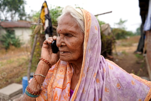 Preview: Senior Indian rural woman talking on phone