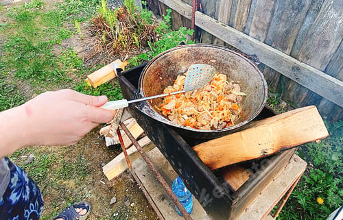 Preview: Cooking Outdoor Meal with Rustic Cast Iron Pot