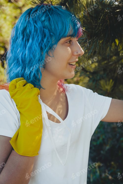 Preview: Volunteer female wearing plastic gloves holding a plastic garbage bag