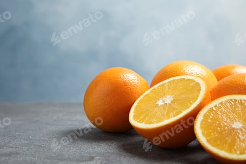 Preview: Fresh oranges on grey table. Space for text