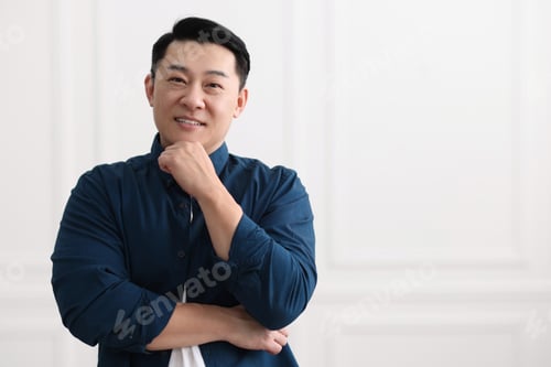 Preview: Portrait of smiling businessman indoors. Space for text