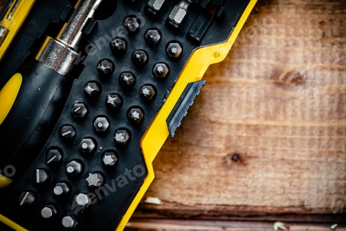 Preview: Working tools. Screwdriver bits. On a wooden background.