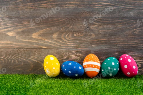 Preview: Happy Easter background. Easter eggs on the grass with wooden background