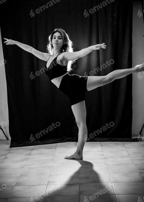 Preview: Young dancer in studio photo session with a black background, ballet