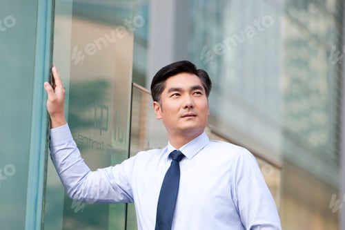 Preview: Chinese businessman by building exterior