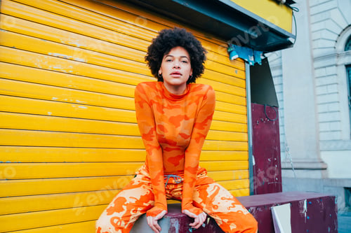 Preview: Confident stylish young black woman posing outdoor cool outfit looking camera