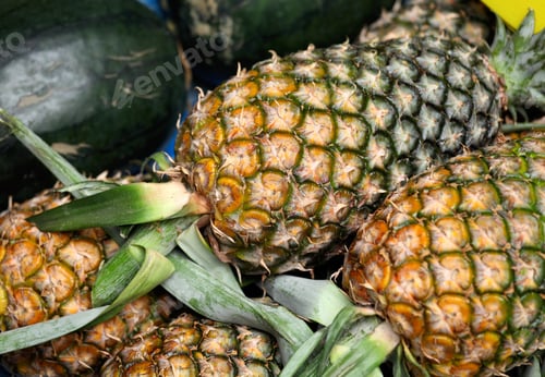 Pile of Pineapples and Watermelons for Sale