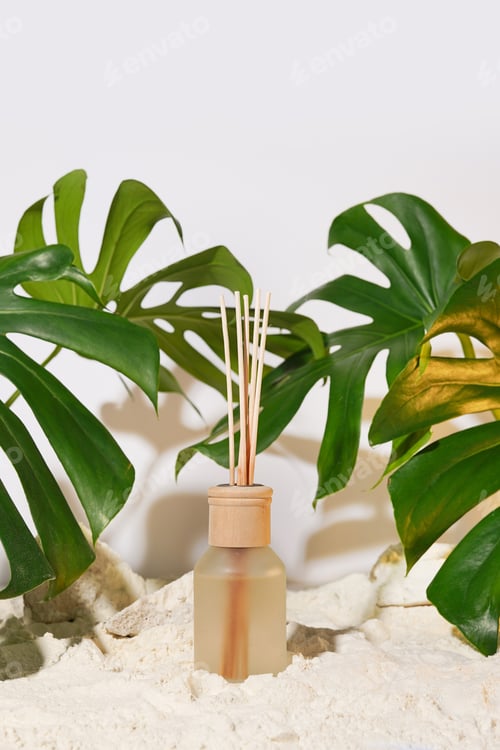 Preview: aroma diffuser bottle and monstera leaves on white background with shadows
