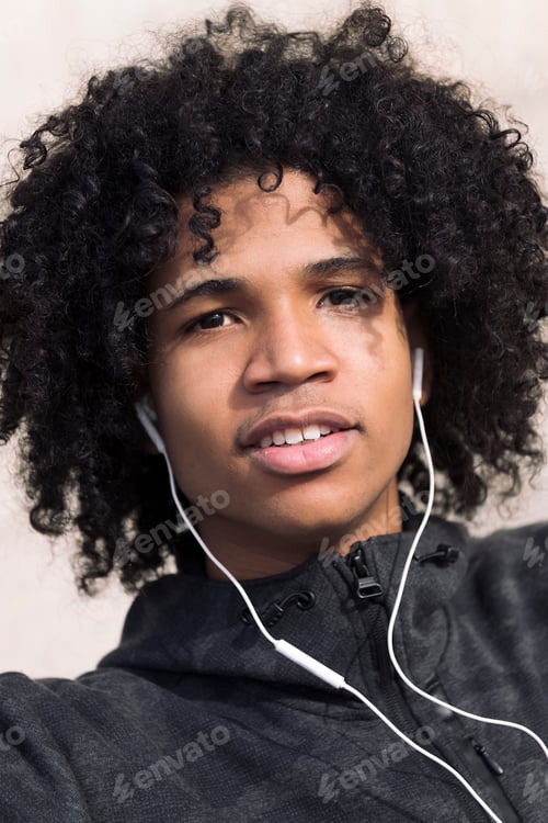 Preview: teenage boy listening music with earphones