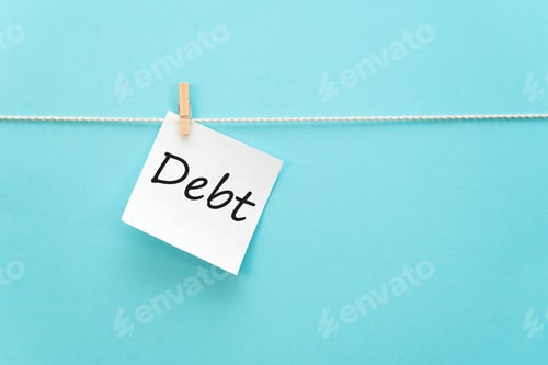Preview: sticker with the inscription Debt hangs with a clothespin on a rope on a blue background