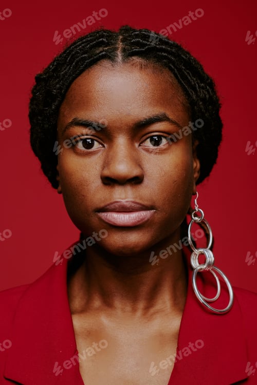 Preview: Portrait of Woman Wearing Statement Earrings on Red Background