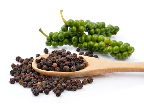 Preview: Black pepper in wooden spoon on white background.