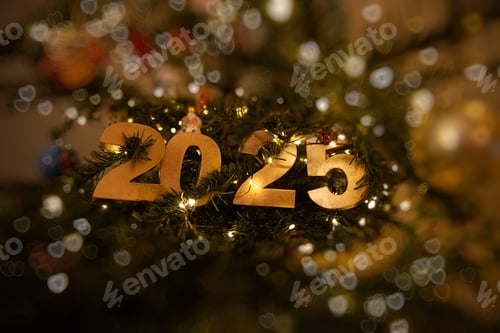 Preview: Horizontal Golden 2025 with bokeh ornament on a decorated Christmas tree
