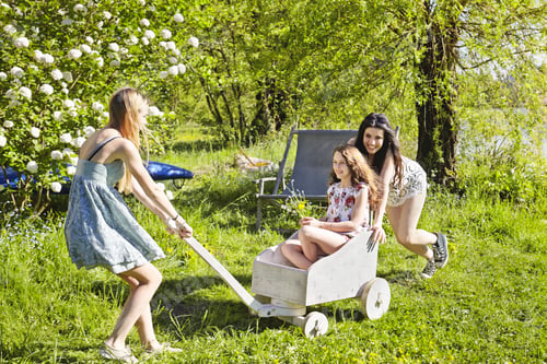 Preview: Young women playing with toy cart