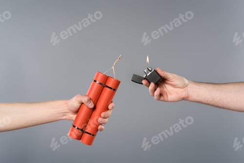 Preview: cropped view of men holding dynamite and lighter on grey background
