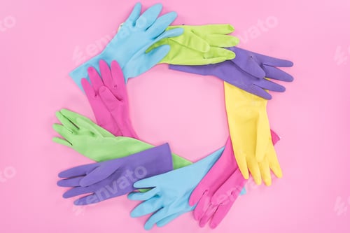 Preview: frame made of multicolored rubber gloves on pink background with copy space