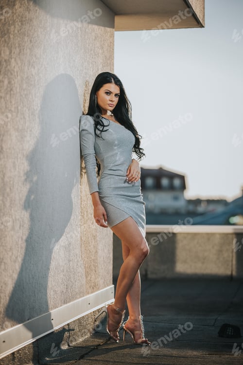 Preview: Attractive woman in a mini dress and heels posing