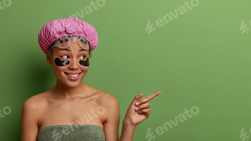 Preview: Happy female model undergoes beauty treatments after taking shower, wears waterproof bath hat and go