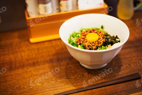 Preview: A ramen noodle shop.A white bowl of noodles with vegetables and an egg.