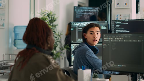 Preview: Asian system engineer asking coder for help with html code